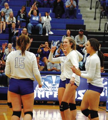Breana Pelbath and her teammates celebrate a point during Tuesday’s contest. HUNTER KING | DISPATCH RECORD
