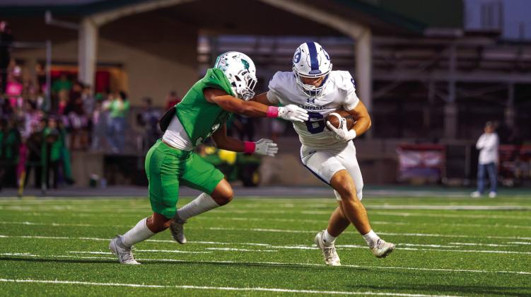 PHOTO BY ANA SOFIA MEYER | DISPATCH RECORD Lampasas junior wide receiver Brayden McLoughlin fends off a tackle and cuts up field against Burnet.