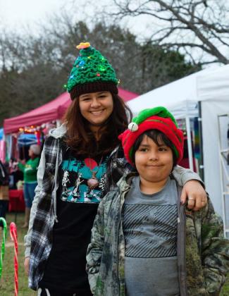 Pacincia Aguayo, at left, wears a colorful, lighted hat handmade by her grandmother to the Kempner Christmas in the Park. She’s pictured with sibling Rosalio Aguayo. Adam Barrios | Dispatch record