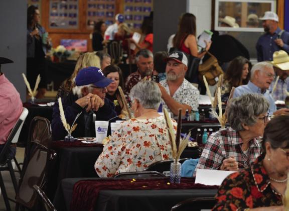 Reverse Raffle attendees enjoy a ribeye steak dinner during last year’s event. A similar meal will be served at this year’s showcase before the live auction gets underway. FILE PHOTO