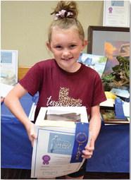 Kylee Davis won junior champion in baked goods with a chocolate cake. ALEXANDRIA RANOLPH | DISPATCH RECORD