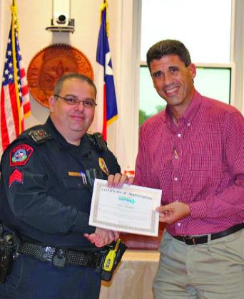 Lampasas ISD Superintendent Dr. Chane Rascoe had praise for School Resource Officer Steve Sheldon, who was named a Community Champion at a meeting of the Lampasas City Council on Monday. Sheldon and Rascoe are pictured left to right. COURTESY PHOTO