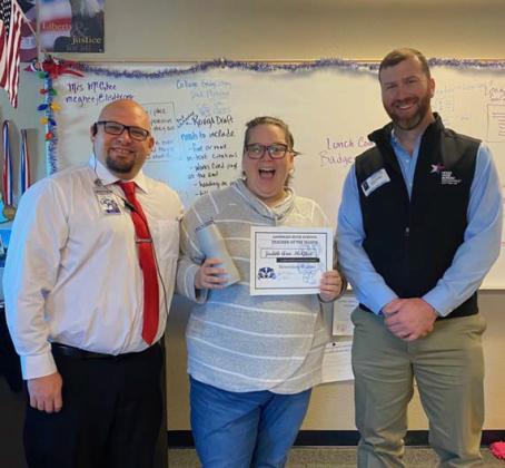 Judith Ann McGhee was recognized recently as the November Teacher of the Month at Lampasas High School. Under her direction, the UIL Academic Team is a two-time district champion. McGhee also teaches English IV. Assistant Principal Ryan Race, at left, and Clay Phillips of Farm Bureau Insurance are pictured with her. COURTESY PHOTO