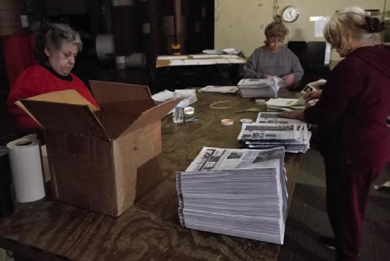 Grace Rangel, left, who has pre-press responsibilities at the printing plant in Taylor; Ory Boney, operations manager; and Janie Mata, inserter, concentrate on getting the Lampasas Dispatch Record and the Boerne Star out the door and back to their respective communities, despite having no electricity at the plant. JIM LOWE | DISPATCH RECORD