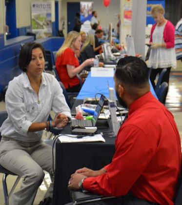 Maria Gonzalez of the Texas Veterans Commission speaks with Jose Garcia at last week’s job fair. MASON HINES | DISPATCH RECORD