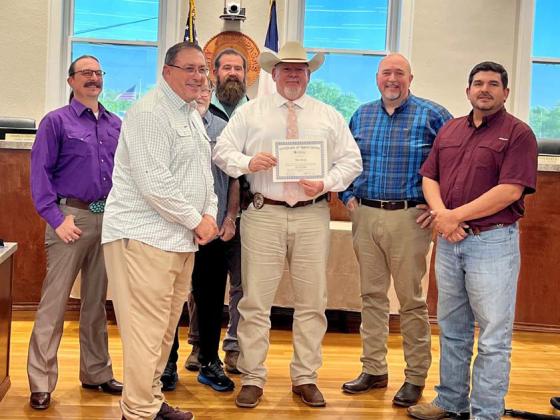 At the March 25 Lampasas City Council meeting, council members recognized Lampasas Police Sgt. Investigator Tim Ryan for his 30 years of service with the department. He is pictured here with Mayor Herb Pearce and members of the council. COURTESY PHOTO | CITY OF LAMPASAS