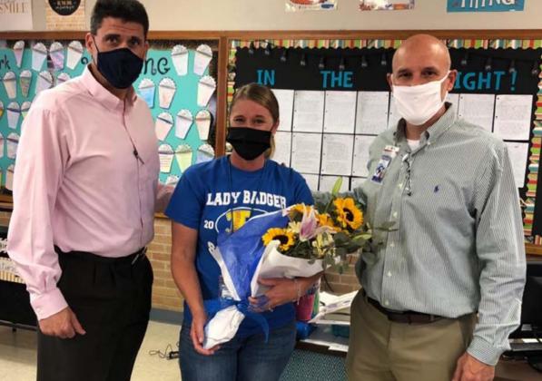 Superintendent Dr. Chane Rascoe, left, and Lampasas Middle School Principal Dana Holcomb congratulate Lacey Plouff on her selection as LISD Secondary Teacher of the Year. COURTESY PHOTO
