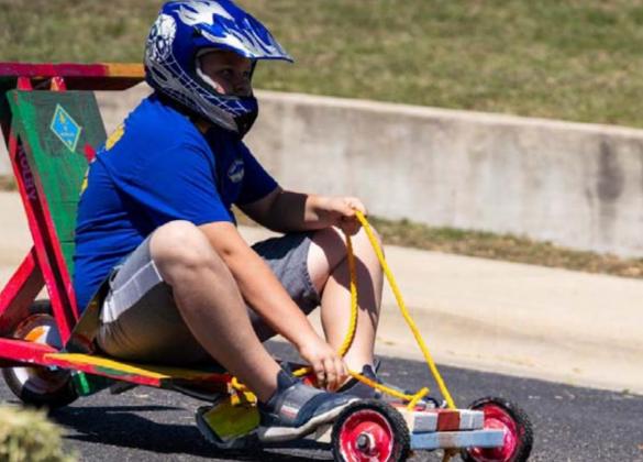 Braydon Lancaster, Pack 100 Webelo Den, reaches for the brakes as he nears the finish line of the Downhill Derby. JEROMIAH LIZAMA | DISPATCH RECORD