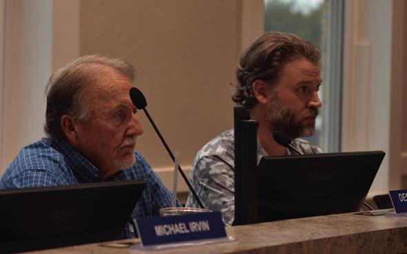 EDC board president Deorald Finney, left, and board vice president Fin Erwin listen to a presentation Wednesday on ways to help building owners pay for costly fire suppression systems and other safety improvements. DISPATCH RECORD