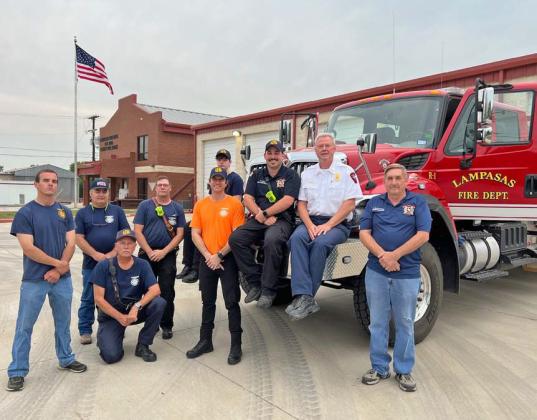 Members of the Lamasas Volunteer Fire Department pose outside the fire station with Lampasas Fire Chief Jeff Smith and one of the fire engines. With volunteer numbers at a low point, there are more vehicles than volunteers available to drive them, officials said. courtesy photo