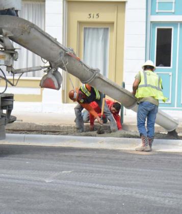 Work crews place cement for the Third Street sidewalks last week. Drivers can now drive on the street, but the project is not entirely completed as of Thursday morning. MONIQUE BRAND | DISPATCH RECORD