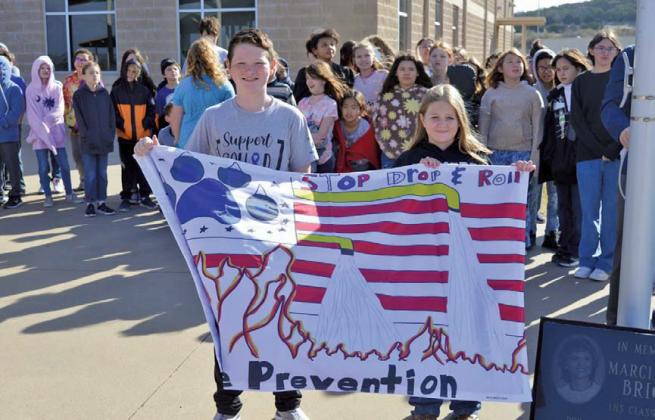 Erich Lent, Keely Riley and Evelyn Walker (not pictured) were responsible for the winning flag design at Taylor Creek Elementary School. erick mitchell | dispatch record