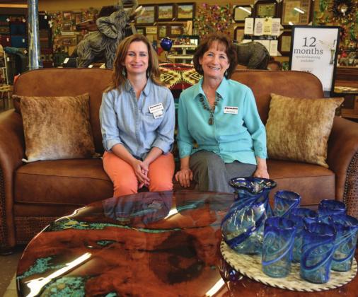 Rustler’s Junction Store Manager Jennifer Chancey, left, and co-owner Carol Chancey pose by a couch upholstered in Texas and a table made in Lampasas County. MADELEINE MILLER | DISPATCH RECORD