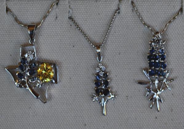 Custom-made Texas and bluebonnet pendants are crafted and sold at Bluestar Jewelers. MADELEINE MILLER | DISPATCH RECORD