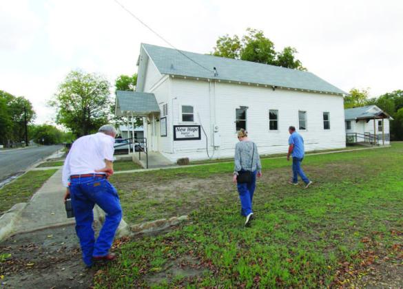 Samantha Hunick, representing Preservation Texas, is accompanied by Boyce Cabiness (left) and Eddie Bowden as they walk towards New Hope Baptist Church. The church is just one of the four landmarks the newly formed Lampasas Cornerstone Conservancy hopes to preserve. JOYCESARAH MCCABE | DISPATCH RECORD