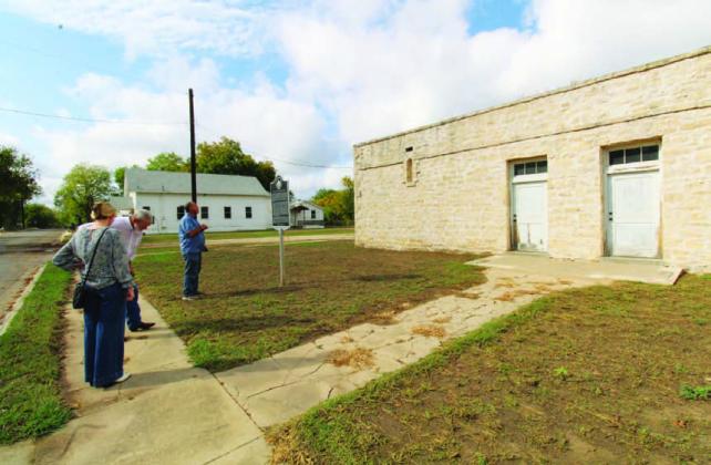JOYCESARAH MCCABE | DISPATCH RECORD Eddie Bowden, Boyce Cabiness (center) and Samantha Hunick, from Preservation Texas, survey and discuss the condition of the Colored School. The school sits beside New Hope Baptist Church and in front of the remains of the Moses Hughes Mill on Sulphur Creek.