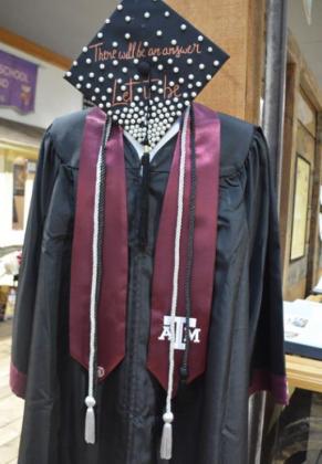A graduation cap and gown of an A&amp;M graduate are on display. MONIQUE BRAND | DISPATCH RECORD