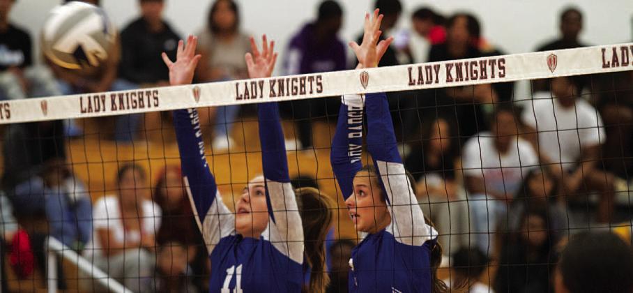 Ava Dowdy, left, and Landry White jump for a block in Harker Heights on Tuesday. HUNTER KING | DISPATCH RECORD