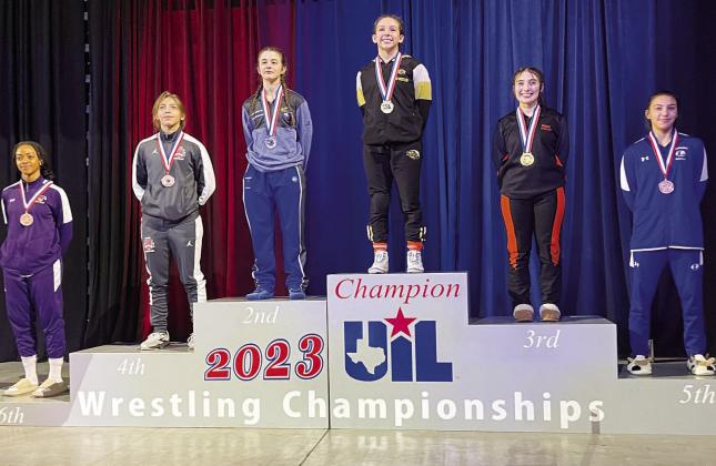 COURTESY PHOTO | LHS WRESTLING TWITTER Charlie Freese, right, stands on the podium in fifth place at the UIL state wrestling championship.