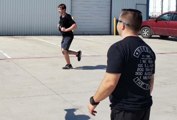 Matt Patrick, coach and owner of the former CrossFit Vector, encourages an athlete on his final run of the 2021 Murph Challenge. ALEXANDRIA RANDOLPH | DISPATCH RECORD