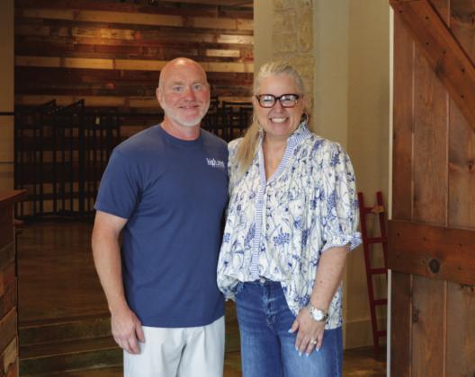 COURTESY PHOTO Merk &amp; Tilley’s owners Jo and John Williams pause for a photo between customer checkouts on their second-to-last day in business on Friday morning.