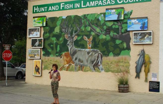 Vision Lampasas member Libby Bluntzer speaks at the 2012 unveiling of the organization’s “Hunt and Fish in Lampasas County” mural. BILL MCDONALD | COURTESY PHOTO