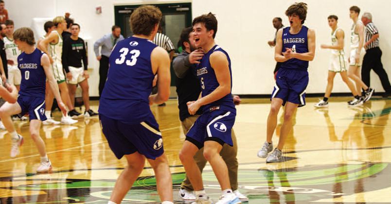 Beau Patterson (33), Trent Seneca (5) and the Badger team celebrate after beating Burnet on the road on Tuesday night. HUNTER KING | DISPATCH RECORD