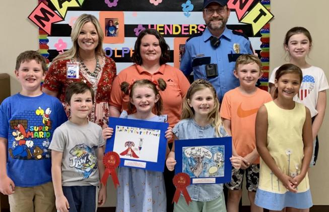 Honored for their participation in the annual Rabies Awareness &amp; Prevention Poster Contest were these Kline Whitis Elementary students: from left, Greyson Moore, Parker Mosebar, Kylee Davis, Ava Latham, Jeb Patterson, Sadie Walker and Hallie Watson. Pictured with them are Principal Leanne Bobo, back row at left, Animal Control Officer Kasey Schwartzer and Animal Control Officer Joseph Schwartzer. COURTESY PHOTO