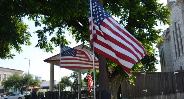 The stars and stripes of the U.S. flag blow in the breeze around the Lampasas County Courthouse last year on Flag Day. FILE PHOTO