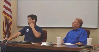 Lampasas ISD Superintendent Dr. Chane Rascoe, at left, and Board of Trustees President Randy Morris look on during a presentation at Monday’s meeting. ERICK MITCHELL | DISPATCH RECORD