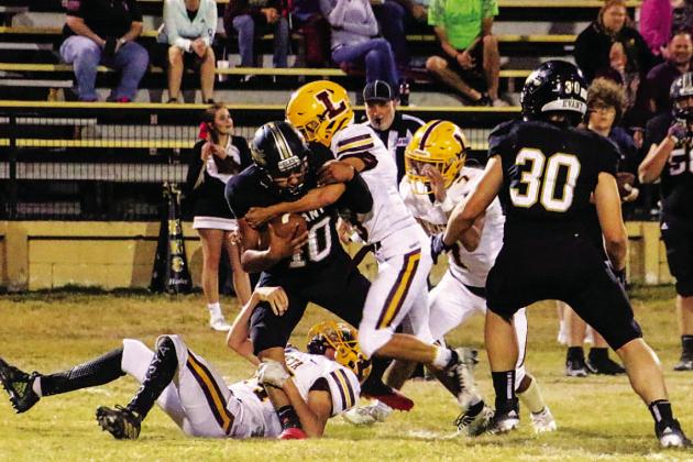 Stone Carr-Jones, Jordan Livesay and Leonel Caso combined to make this tackle during the win over Evant. COURTESY PHOTO | MEGAN LUSTY