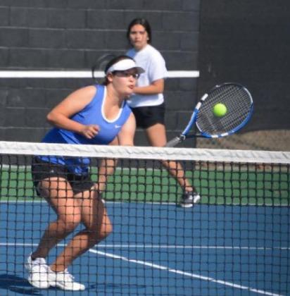 Kelsea Moyer hits the ball near the net while her doubles partner Abriana Flores plays the baseline. KENNETH PEISER | COURTESY PHOTO