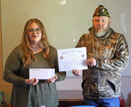 joycesarah mccabe | dispatch record Mandy Jordan, a 10th- grader at Learning Steady Academy, accepts a scholarship award from Lampasas VFW Commander Chris Adolph. Jordan had the winning audio essay answering the question, “What are the greatest attributes of our democracy?”