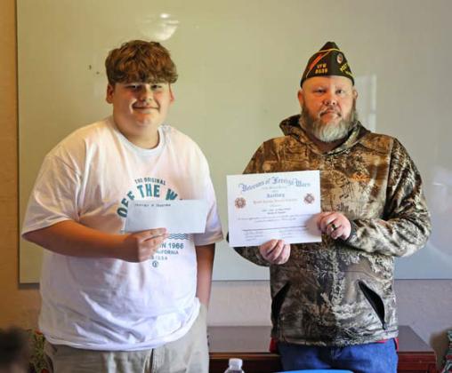 joycesarah mccabe | dispatch record Lampasas VFW Commander Chris Adolph awards Bentley Degetry, an eighth-grade student at Learning Steady Academy, a scholarship for his winning essay on the topic “How are you inspired by America?”