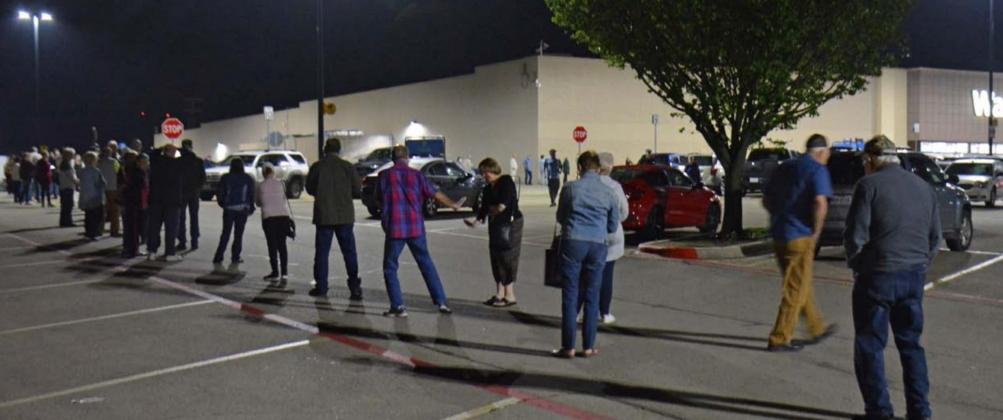 Shoppers flood the Walmart parking lot, waiting for the store to open one morning in March. Many businesses were ordered closed to in-person service in the early days of the coronavirus outbreak, and shelves were wiped clean of items including toilet paper. FILE PHOTO