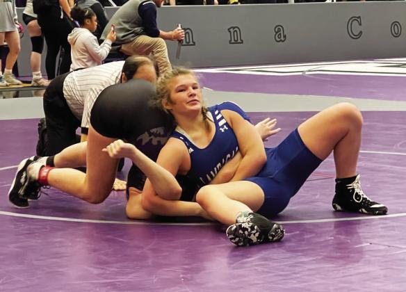 Taylor Martell attempts to pin her opponent during a match at the regional wrestling meet in Anna last weekend. COURTESY PHOTO | LAMPASAS WRESTLING