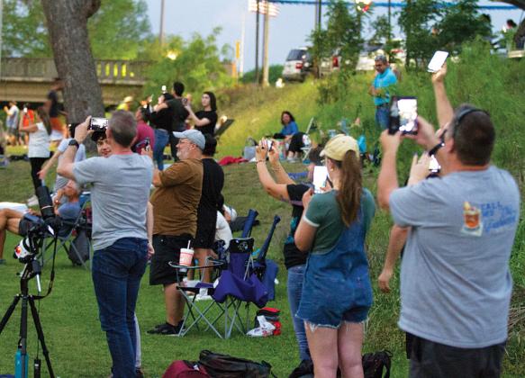 Onlookers at W.M. Brook Park take photos and videos of totality as darkness fell over Lampasas during the solar eclipse on Monday afternoon. hunter king | DISPATCH RECORD