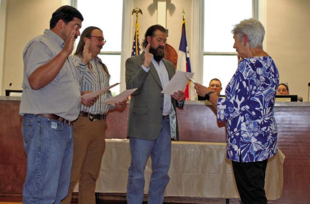 Outgoing Mayor TJ Monroe administers the oath of office to newly elected Lampasas City Council members, from left, Eric Hernandez, Zachary Morris and Charles Pratus. Hernandez and Pratus are serving their first terms, while Morris was re-elected May 6 for a new term on the council. COURTESY PHOTO