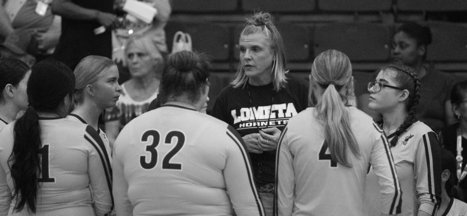PHOTO BY ANA SOFIA MEYER Coach Madison Morris gives a pep talk to her team. The Lady Hornets are looking for their first district win.