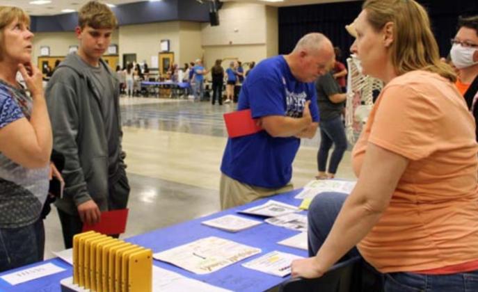 Math teachers Kristina Hopkins and Patricia Bird, at right, discuss different math classes with incoming freshmen and their parents at the Eighth-Grade Night held March 1. FILE PHOTO