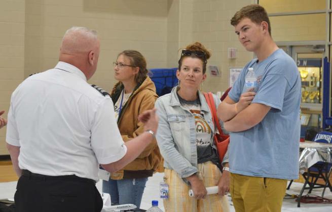 Bo Patterson and his mother, Amanda, visit at the Aviation Career Day with those in the aviation field about job options that are opening up. erick mitchell | dispatch record