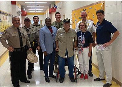 First responders from the Lampasas County Sheriff’s Department and Lampasas Fire Department and members of the Lampasas school district administration pose for a photo with a Vietnam War veteran who was in attendance for Monday’s memorial event. COURTESY PHOTO