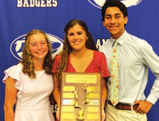 Abby Valdez, left, Kailr Clements and James Vasquez pose with the Battlin’ Badger award on Monday night. COURTESY PHOTO