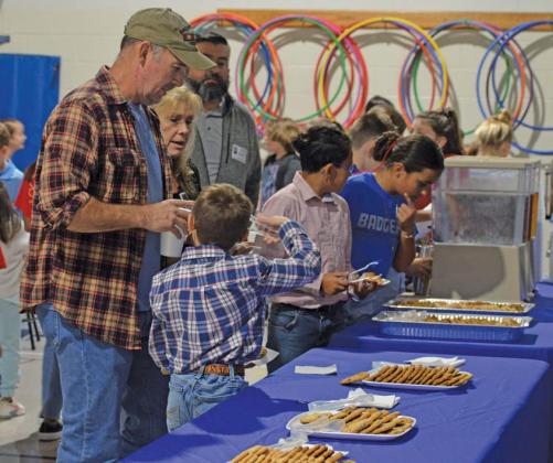 Students involved in the Hanna Springs Elementary School student leadership group “World Changers” assist veterans with their coffee, tea and cookies during Thursday’s Veterans Day reception. erick mitchellE | DISPATCH RECORD