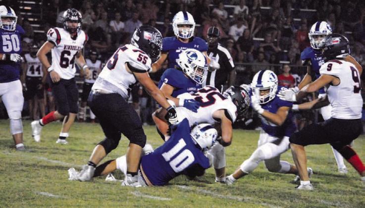 Brock Langford (10) and Reed Jerome (3) are in on the tackle of the Wimberley ball carrier. HUNTER KING | DISPATCH RECORD
