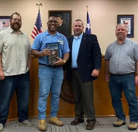 Kempner Iron and Metal manager Walter Gibson, center, holds his Impression Award. He is pictured with city officials, from left, Councilman Dan Long, Mayor John Wilkerson and Councilman Tom Combs. CITY OF KEMPNER FACEBOOK PAGE