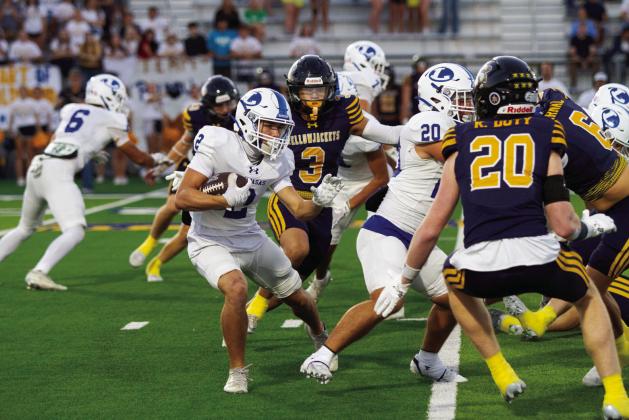 Jonathan Bowling returns the opening kickoff at Stephenville, weaving through defenders. PHOTO BY ANA SOFIA MEYER | DISPATCH RECORD