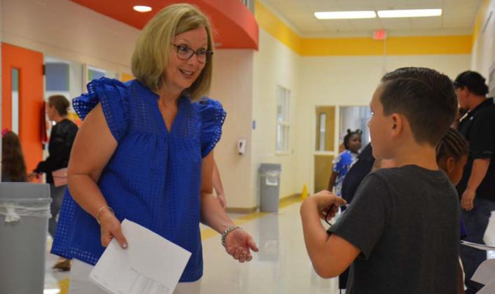 monique brand | Dispatch Record Taylor Creek Principal Shona Moore, shown visiting with students before class, attributes success rates on STAAR tests to teachers’ efforts to coordinate their lesson plans and having good interaction with students.