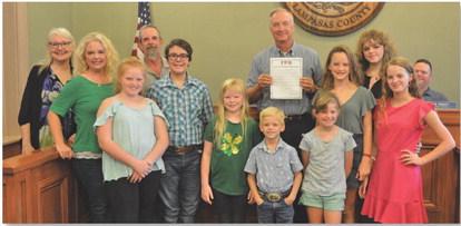 Lampasas County 4-H leaders and members pose for a photo with County Judge Randy Hoyer on Monday. The Lampasas County Commissioners Court approved a proclamation calling for the celebration of National 4-H Week, which starts on Sunday. ERICK MITCHELL | DISPATCH RECORD