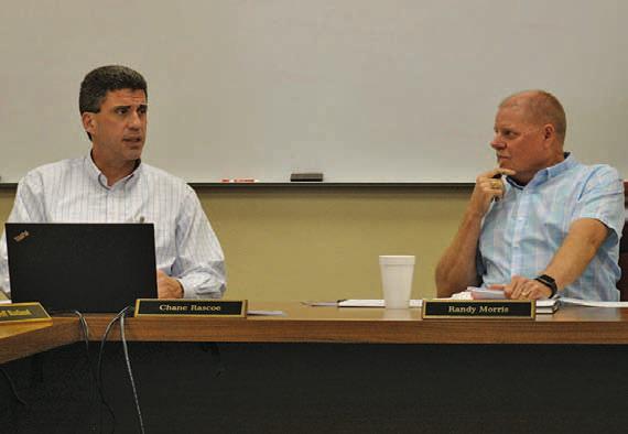 Lampasas ISD Superintendent Dr. Chane Rascoe, left, and LISD Board of Trustees President Randy Morris discuss business during the January school board meeting. ERICK MITCHELL | DISPATCH RECORD